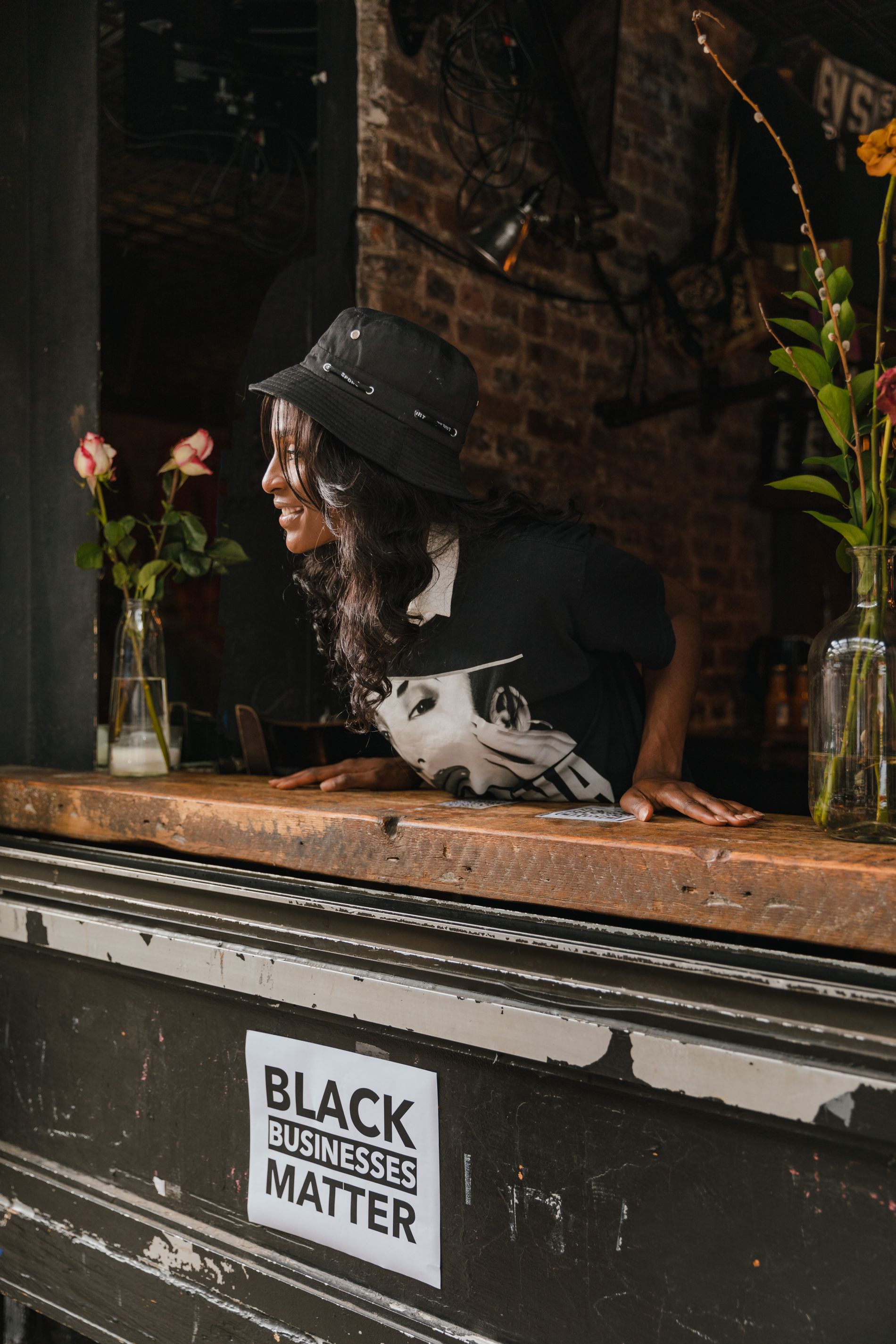 A Black business owner smiling in her cafe