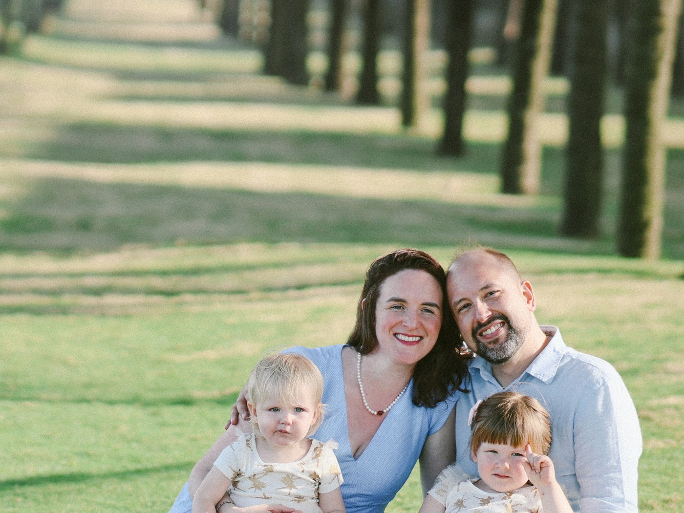 A family of four relaxing together outdoors