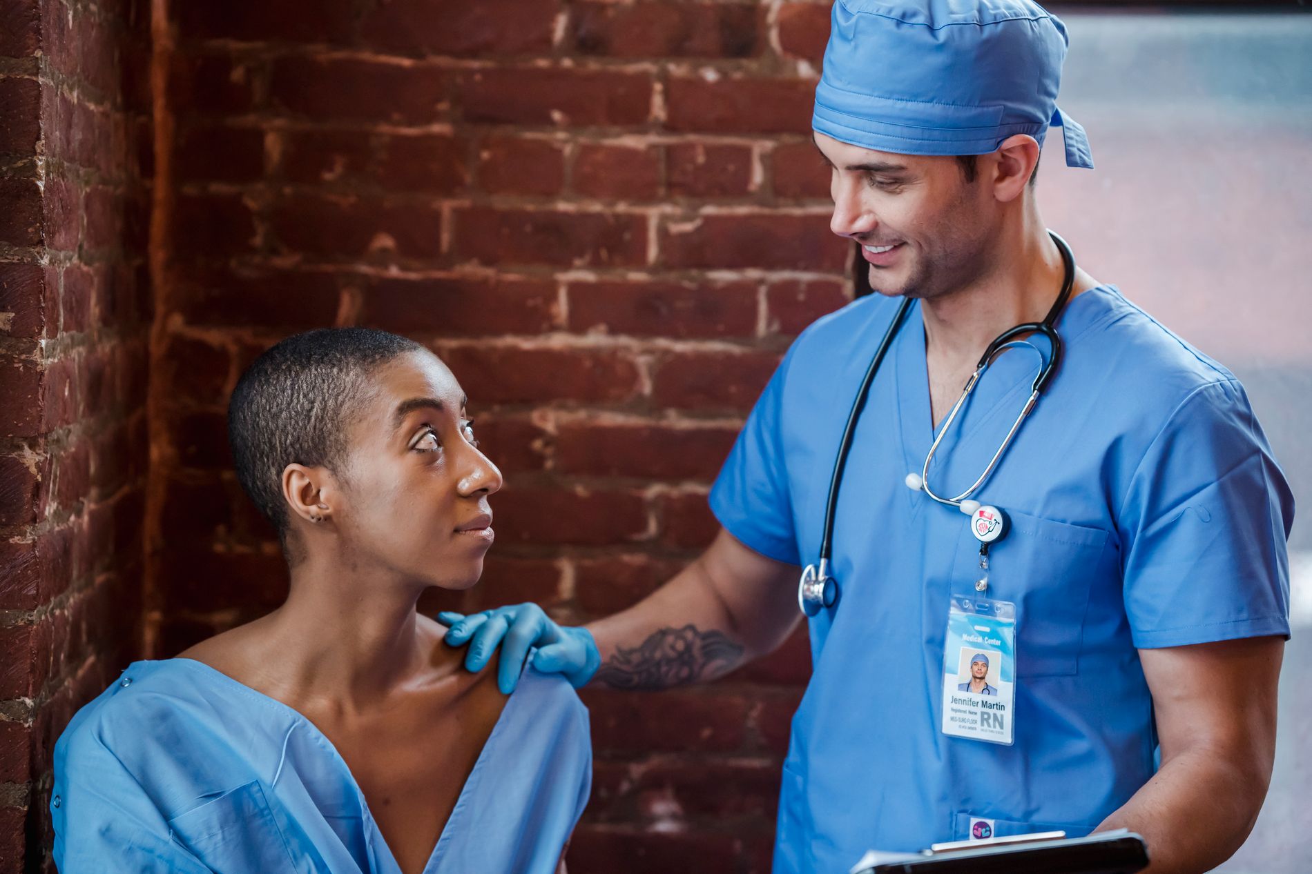 A doctor speaking with a Black patient in a clinic