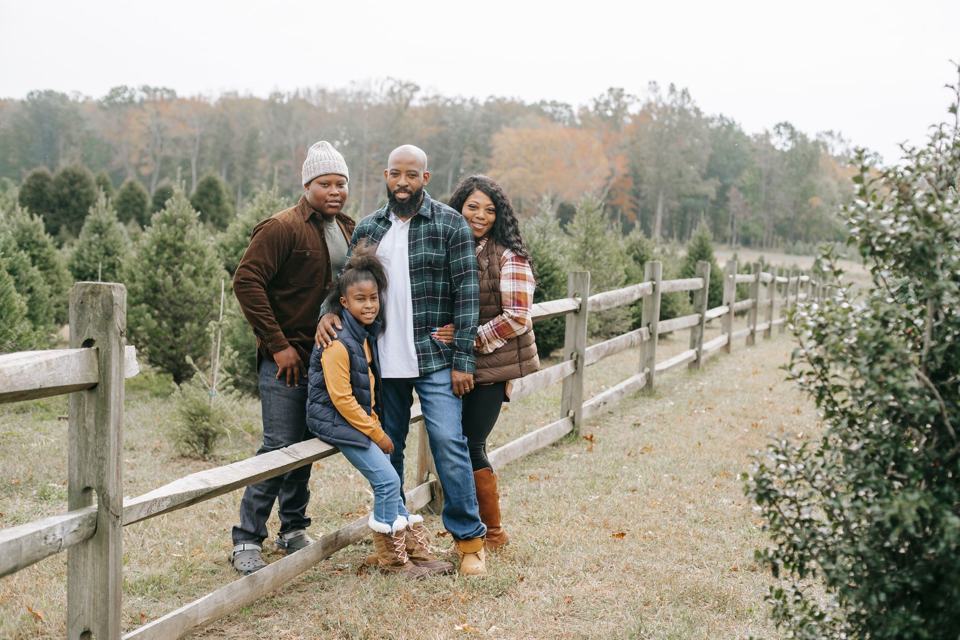 A Black family smiling together outdoors