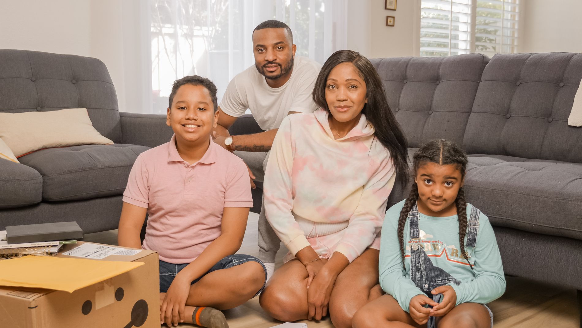 A Black family smiling together outdoors