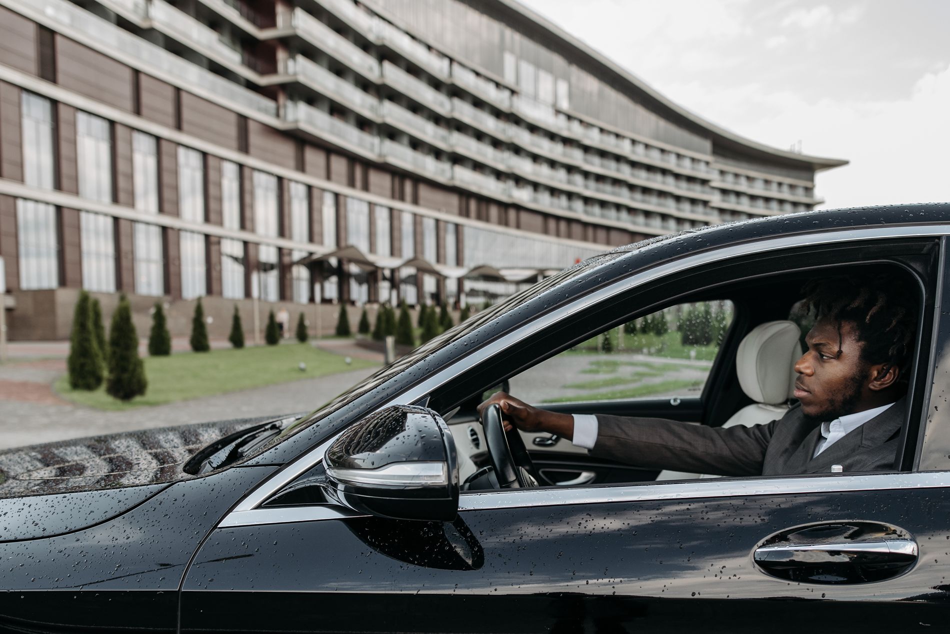 A Black man driving a car