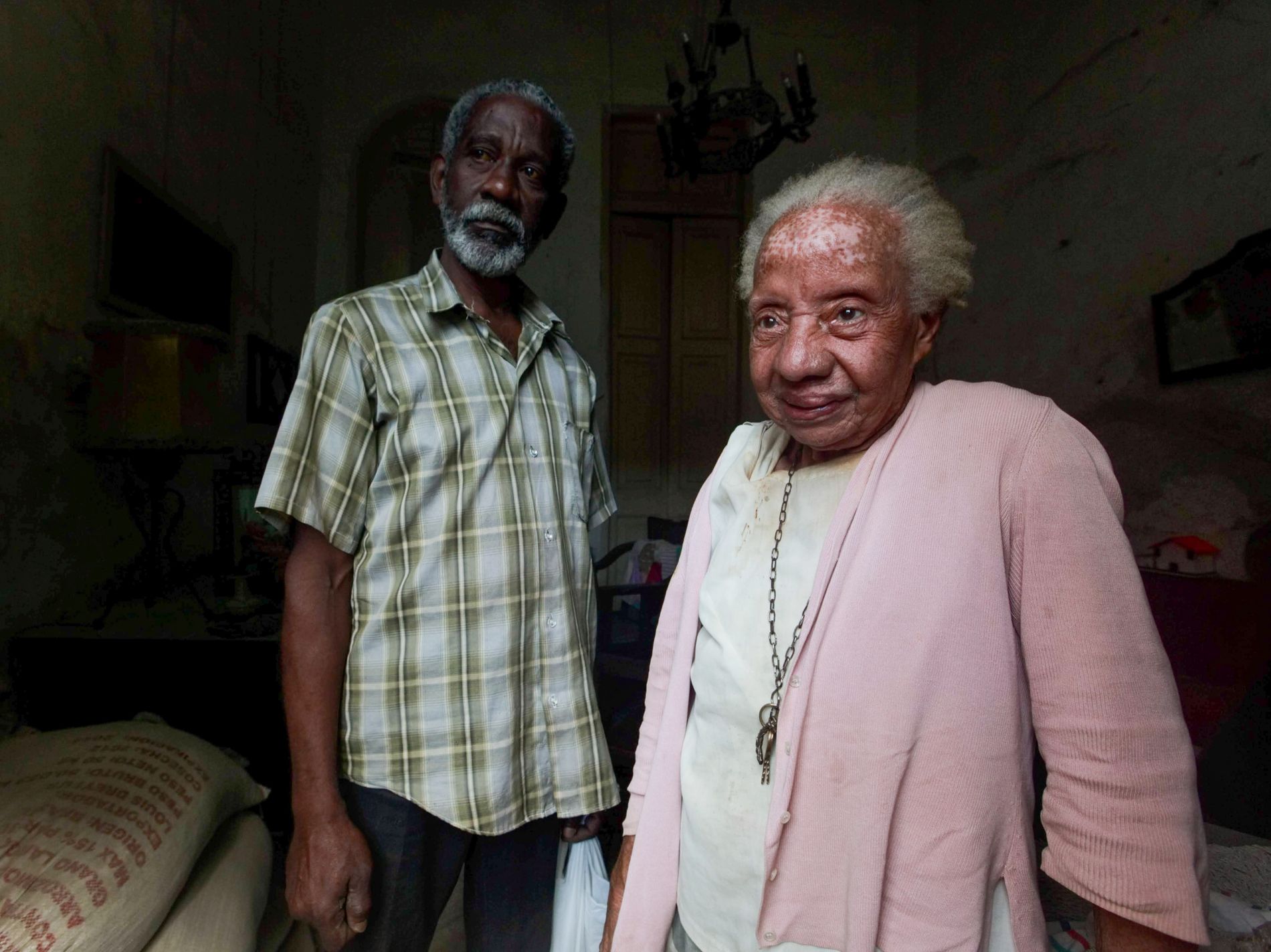 A Black senior couple standing together at home
